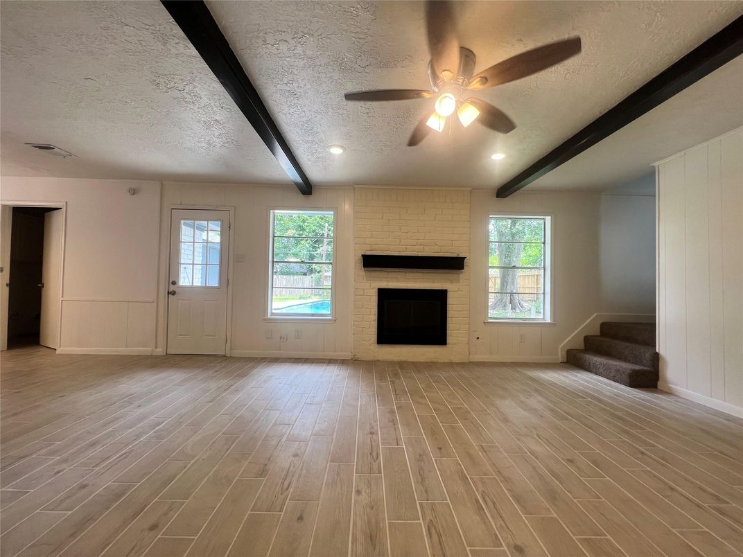 Empty room, Fireplace, Interior, Recessed Lighting, Stone Walls, Wood Texture Flooring