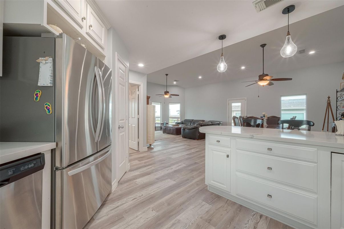 Dining room, Interior, Kitchen, Pendant Lights, Recessed Lighting, Stainless Steel Appliances, Wood Texture Flooring