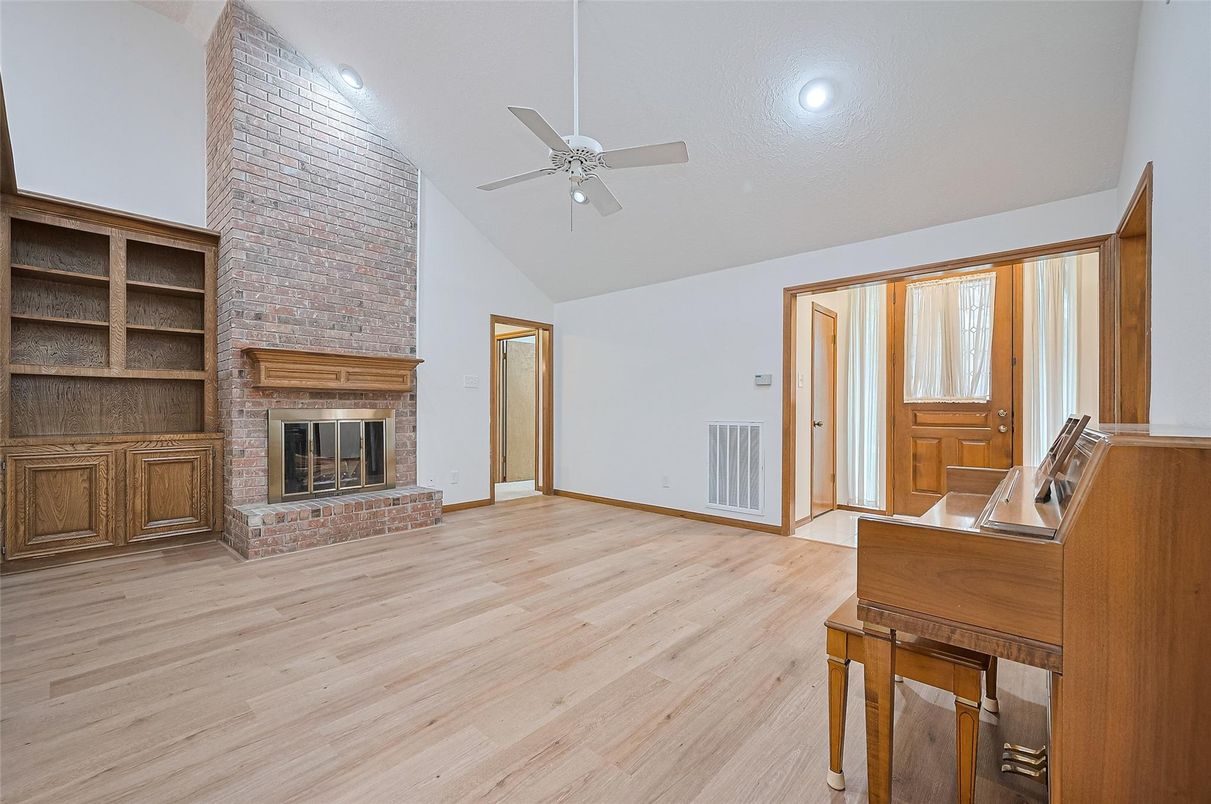 Empty room, Fireplace, Interior, Piano, Recessed Lighting, Stone Walls, Wood Texture Flooring