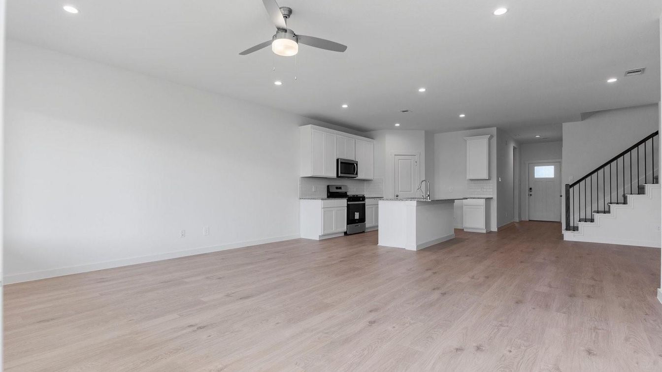 Empty room, Interior, Kitchen, Recessed Lighting, Stainless Steel Appliances, Wood Texture Flooring
