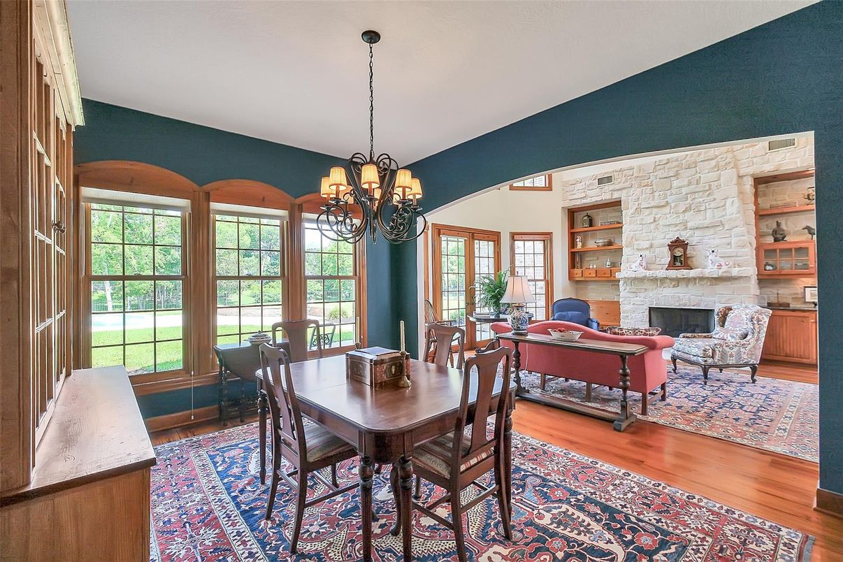 Chandelier, Dining room, Fireplace, Interior, Living room, Stone Walls, Wood Texture Flooring