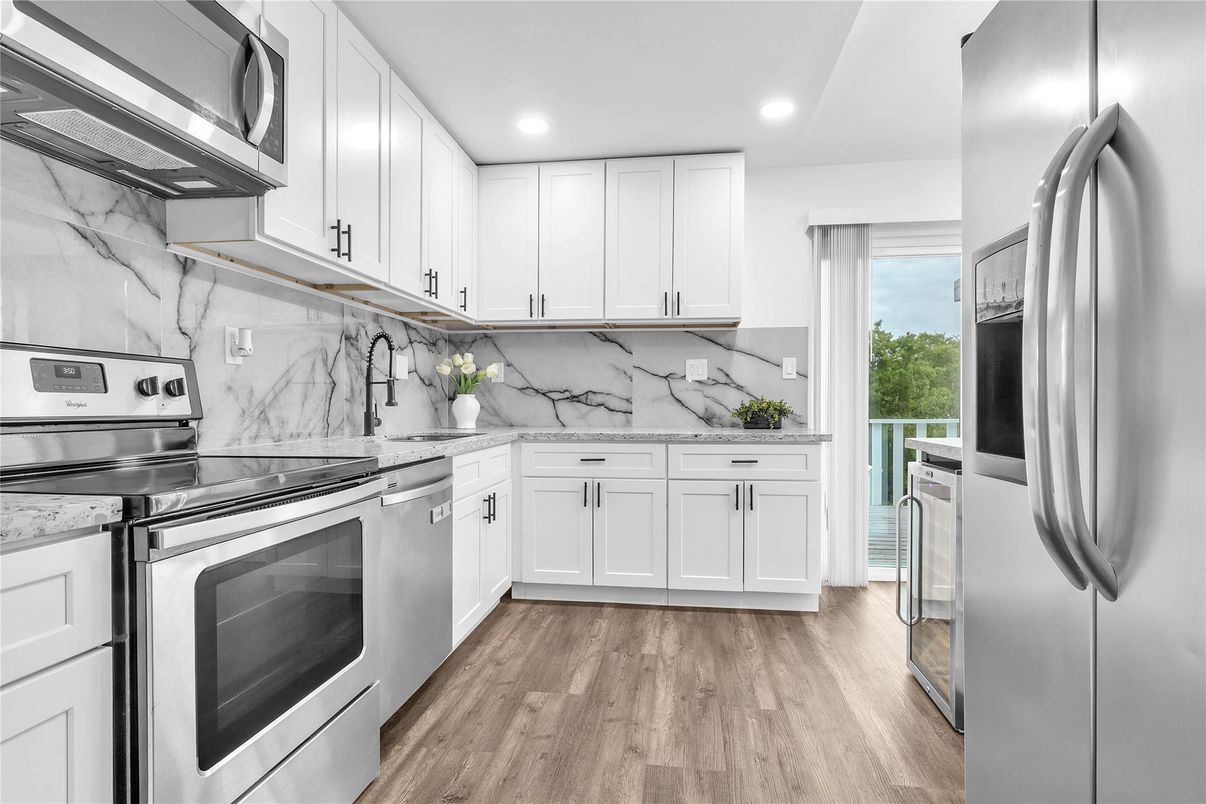 Interior, Kitchen, Marble Walls, Recessed Lighting, Stainless Steel Appliances, Wood Texture Flooring