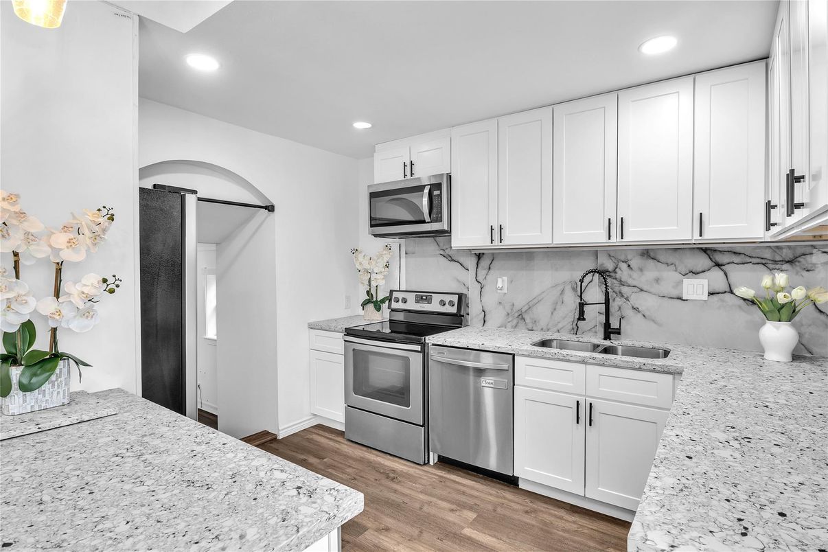 Interior, Kitchen, Marble Walls, Recessed Lighting, Stainless Steel Appliances, Wood Texture Flooring