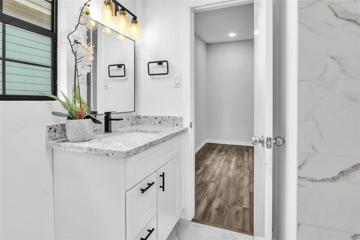 Bathroom, Dual Sink Vanities, Interior, Marble, Marble Walls, Recessed Lighting, Wood Texture Flooring
