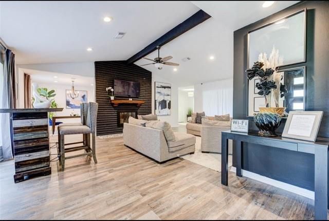 Chandelier, Dining room, Fireplace, Interior, Living room, Pendant Lights, Recessed Lighting, Wood Texture Flooring, Wooden Walls