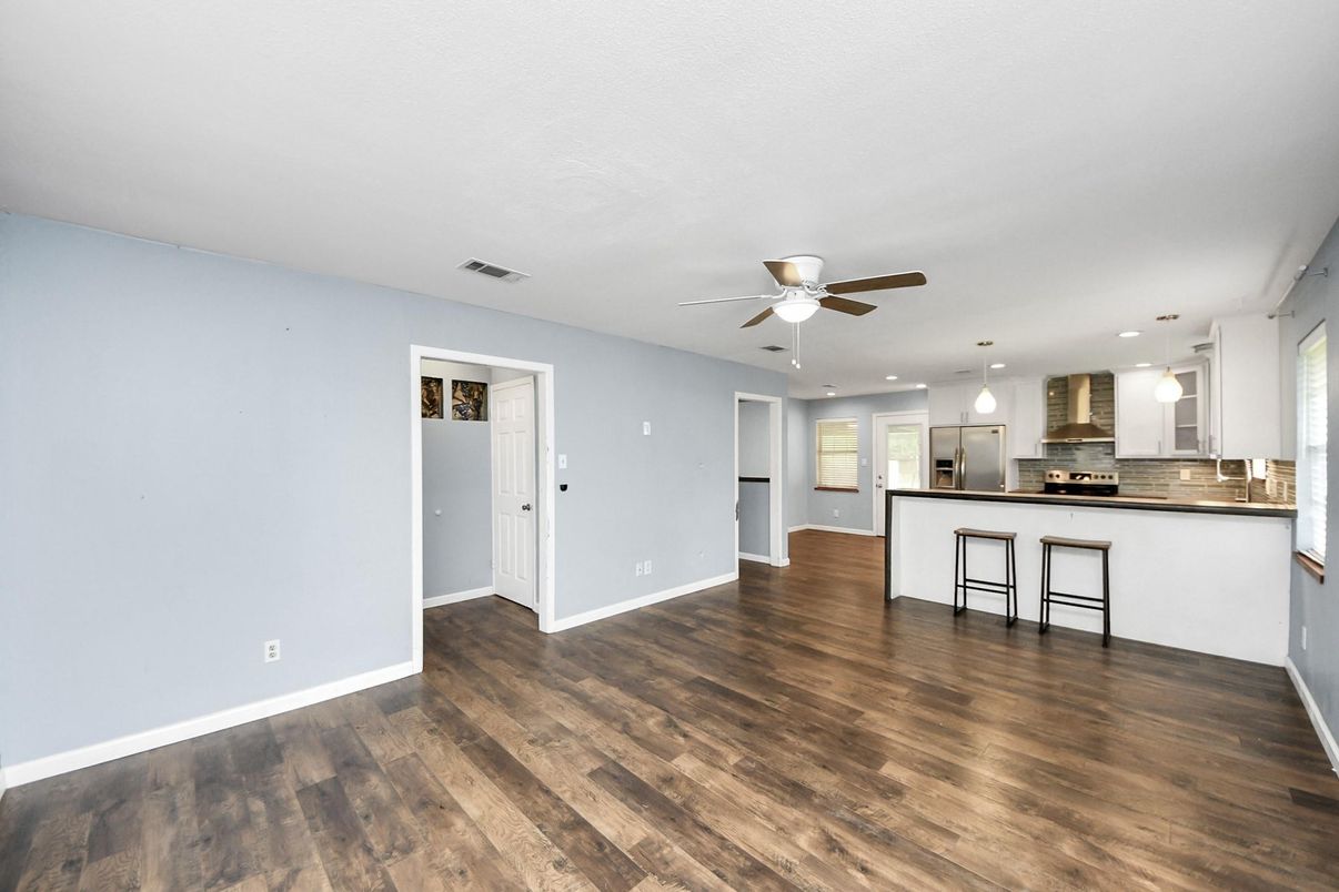 Empty room, Interior, Kitchen, Pendant Lights, Recessed Lighting, Stainless Steel Appliances, Wood Texture Flooring