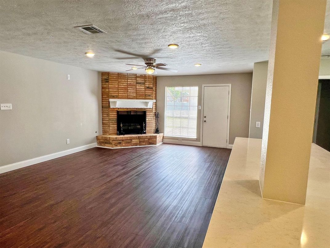 Empty room, Fireplace, Interior, Recessed Lighting, Stone Walls, Wood Texture Flooring