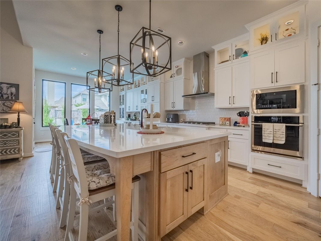 Dining room, Interior, Kitchen, Pendant Lights, Recessed Lighting, Stainless Steel Appliances, Wood Texture Flooring