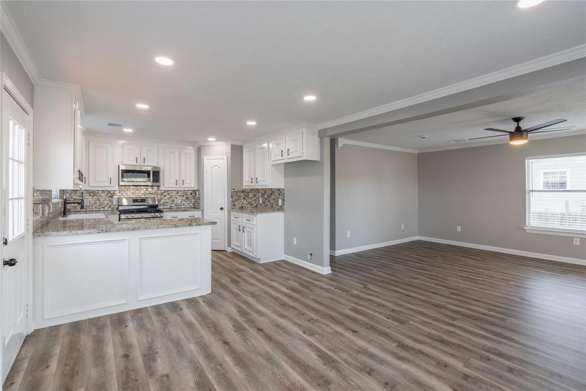 Empty room, Interior, Kitchen, Recessed Lighting, Stainless Steel Appliances, Wood Texture Flooring