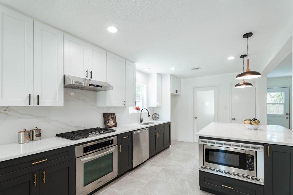 Interior, Kitchen, Marble Walls, Pendant Lights, Recessed Lighting, Stainless Steel Appliances