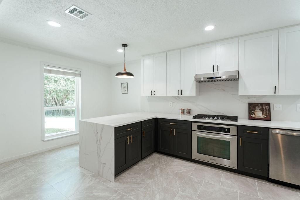 Interior, Kitchen, Marble Walls, Pendant Lights, Recessed Lighting, Stainless Steel Appliances