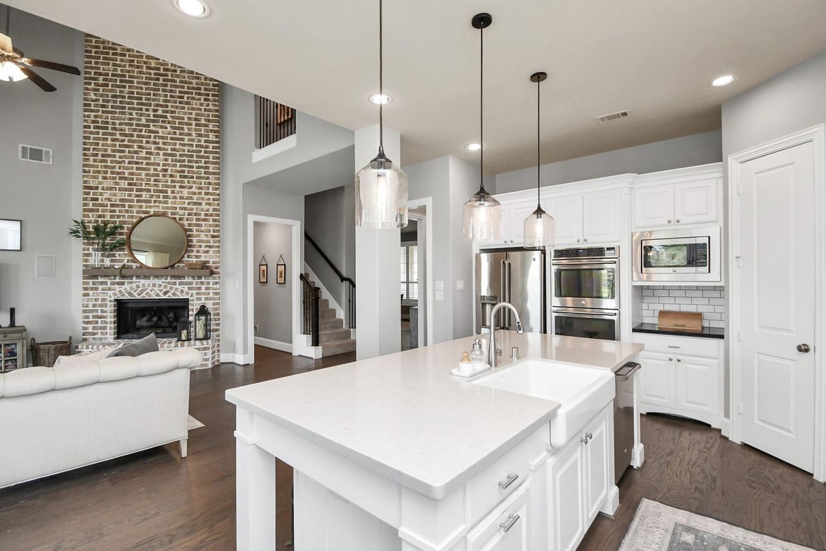 Fireplace, Interior, Kitchen, Living room, Pendant Lights, Recessed Lighting, Stainless Steel Appliances, Stone Walls, Wood Texture Flooring