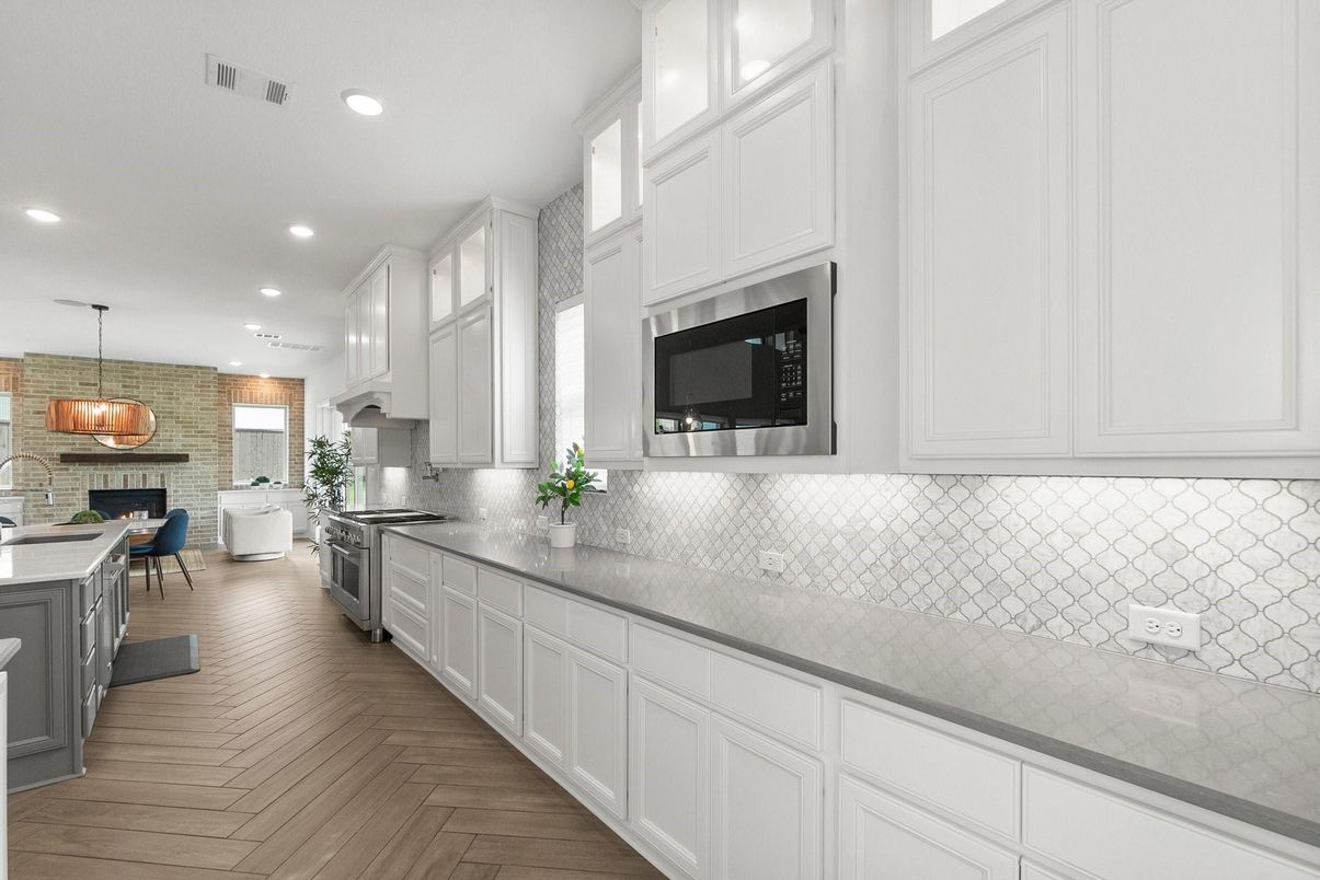 Dining room, Fireplace, Interior, Kitchen, Pendant Lights, Recessed Lighting, Stainless Steel Appliances, Stone Walls, Wood Texture Flooring