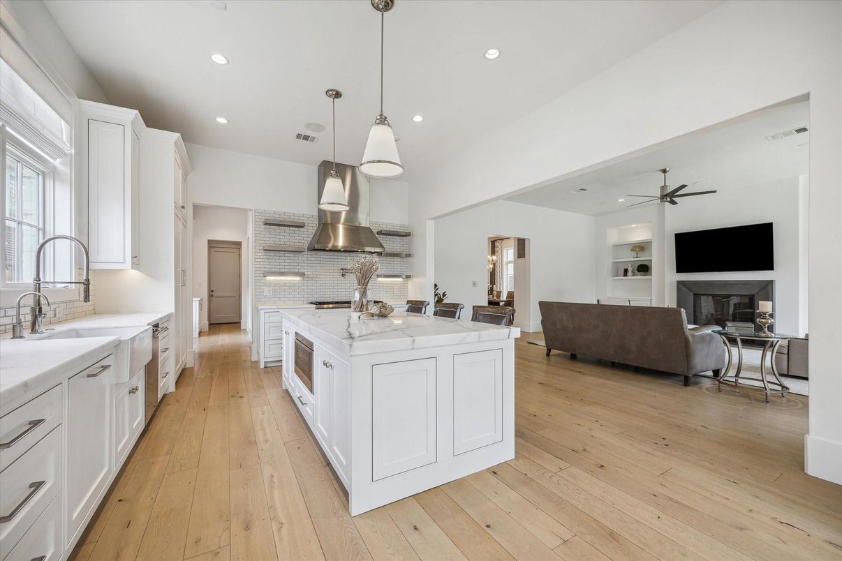 Fireplace, Interior, Kitchen, Living room, Pendant Lights, Recessed Lighting, Stainless Steel Appliances, Wood Texture Flooring