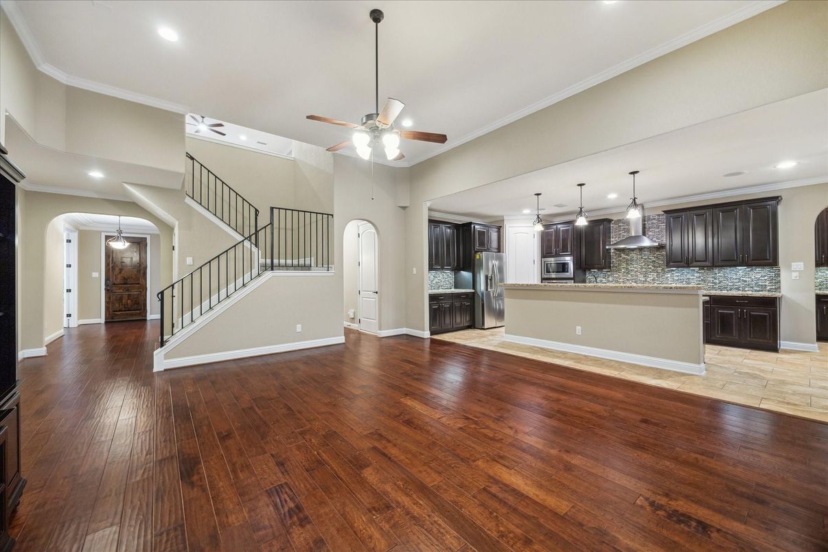 Empty room, Interior, Kitchen, Pendant Lights, Recessed Lighting, Stainless Steel Appliances, Wood Texture Flooring