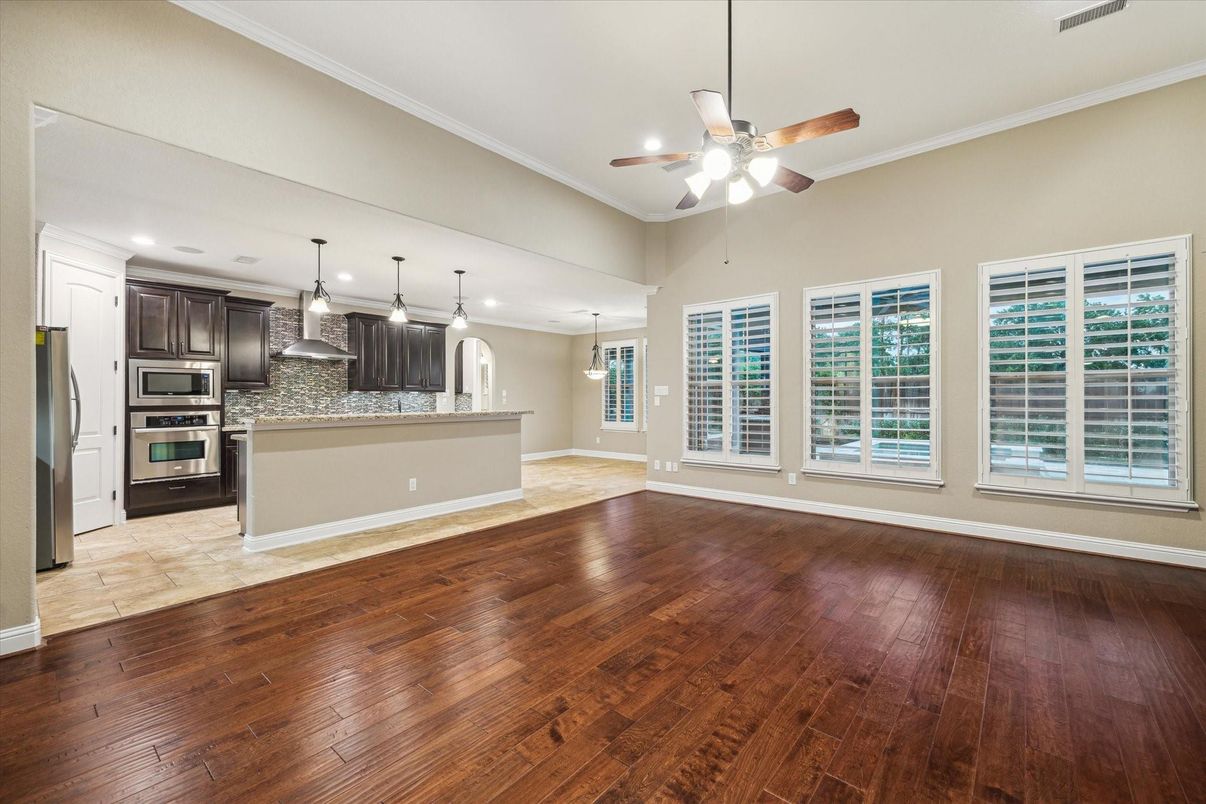Empty room, Interior, Kitchen, Pendant Lights, Recessed Lighting, Stainless Steel Appliances, Wood Texture Flooring