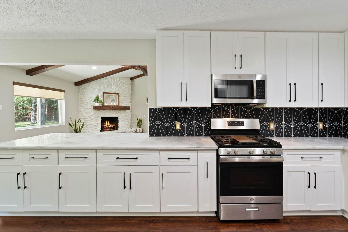 Fireplace, Interior, Kitchen, Recessed Lighting, Stainless Steel Appliances, Stone Walls, Wooden Beams, Wood Texture Flooring