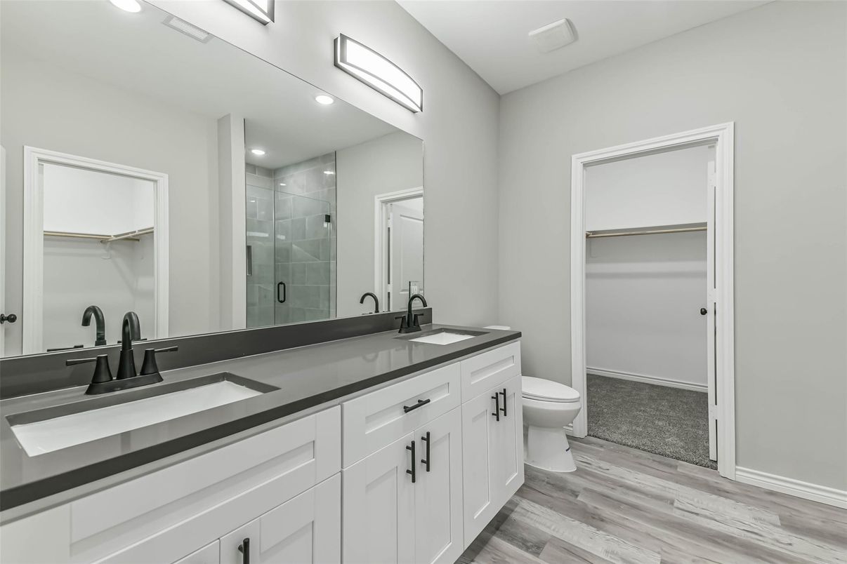 Bathroom, Dual Sink Vanities, Glass Shower, Interior, Recessed Lighting, Wood Texture Flooring
