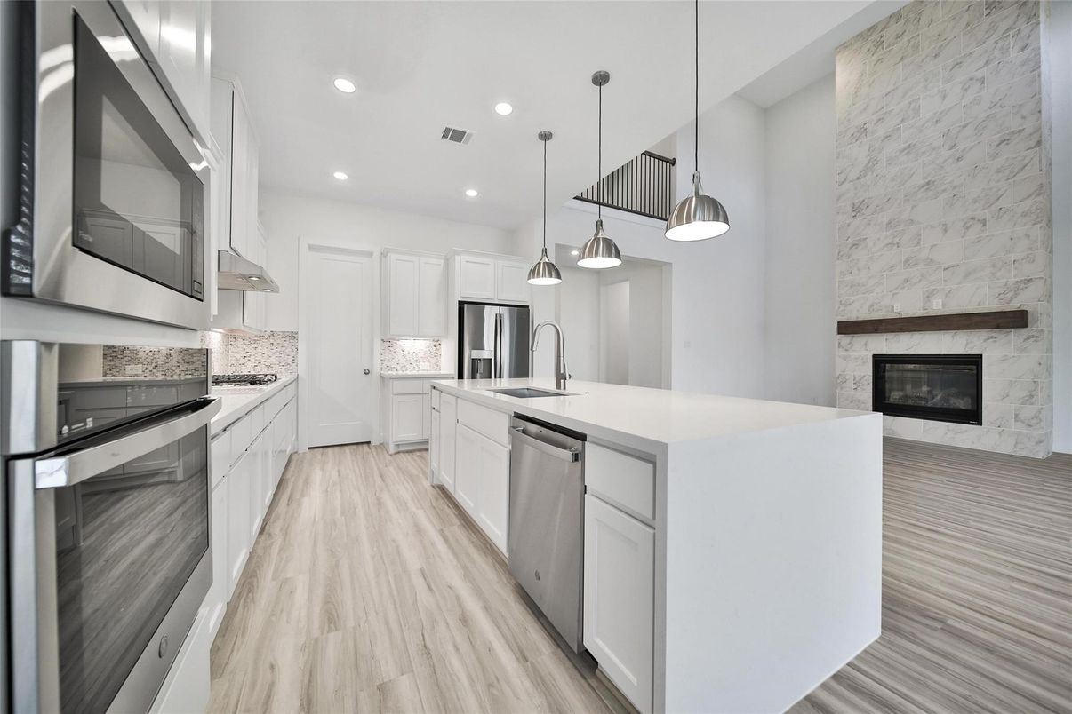Fireplace, Interior, Kitchen, Pendant Lights, Recessed Lighting, Stainless Steel Appliances, Wood Texture Flooring