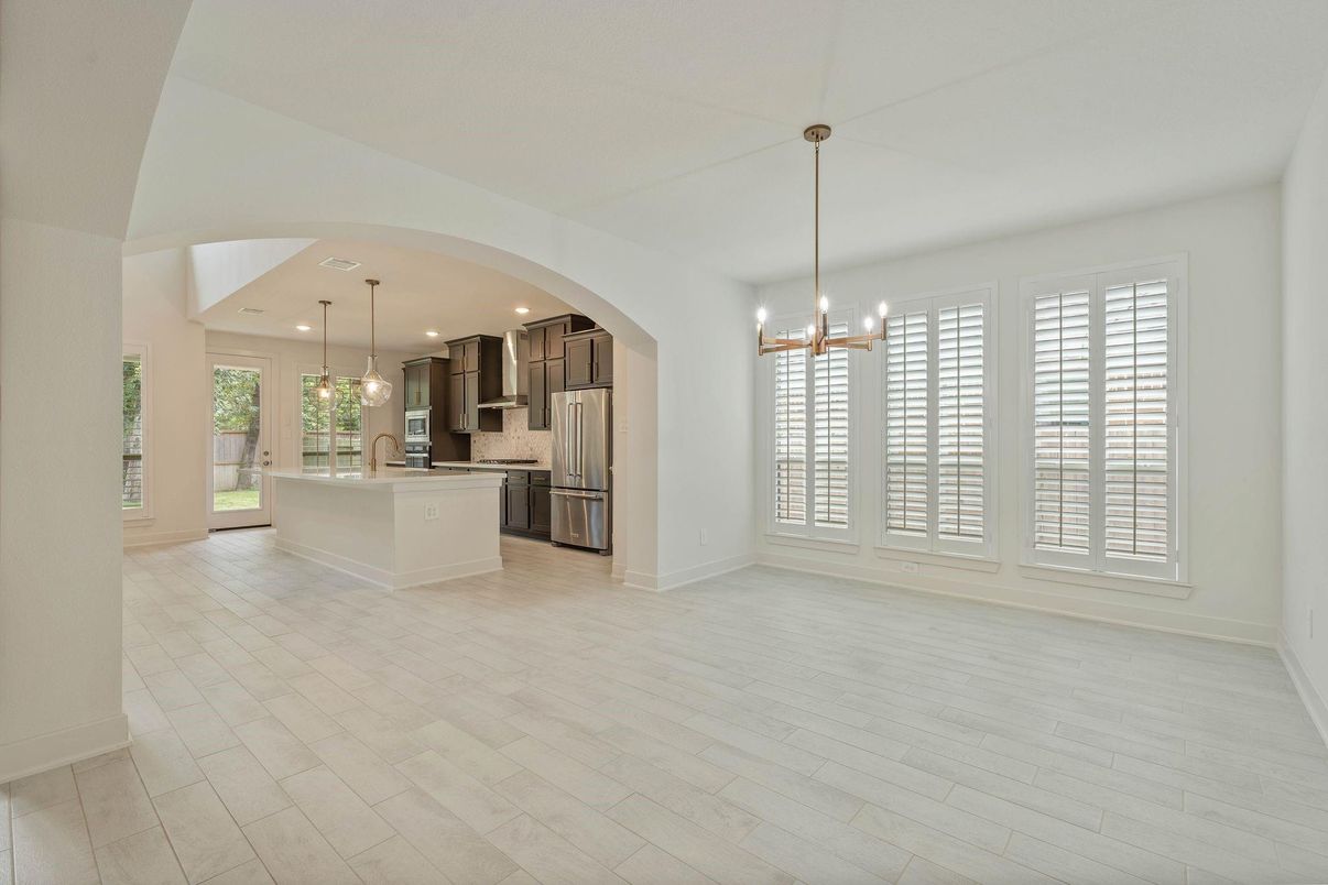 Empty room, Interior, Kitchen, Pendant Lights, Recessed Lighting, Stainless Steel Appliances, Wood Texture Flooring