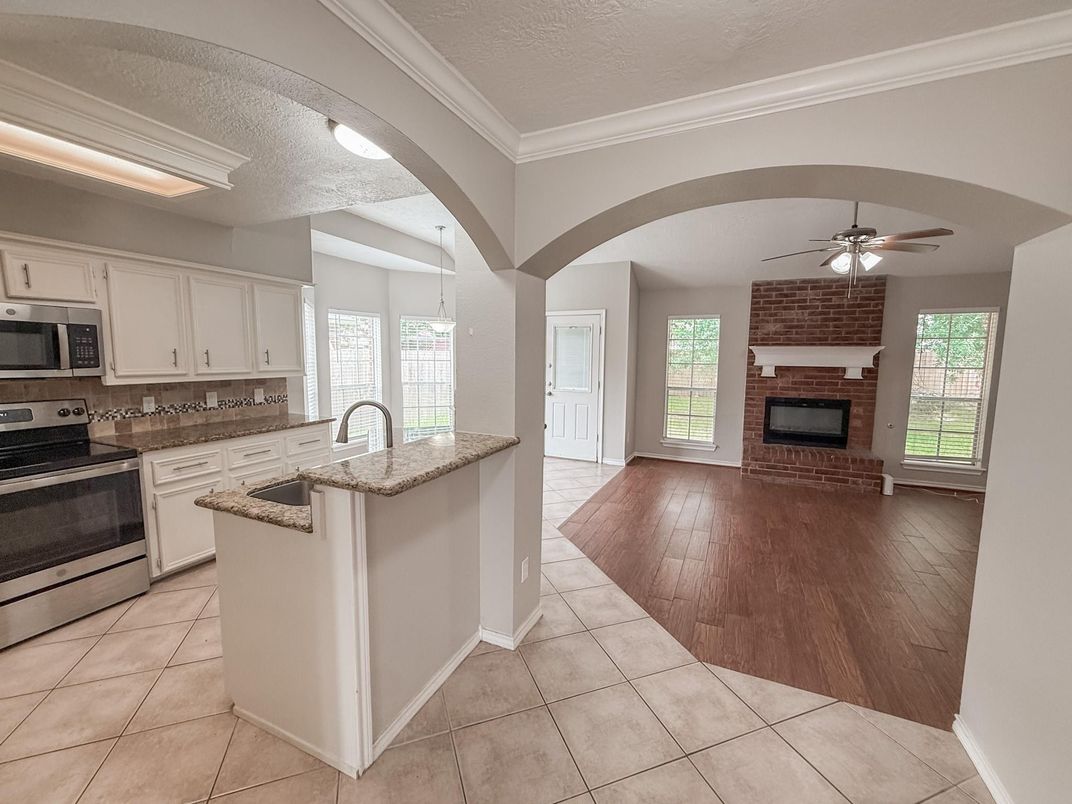 Fireplace, Interior, Kitchen, Stainless Steel Appliances, Wood Texture Flooring