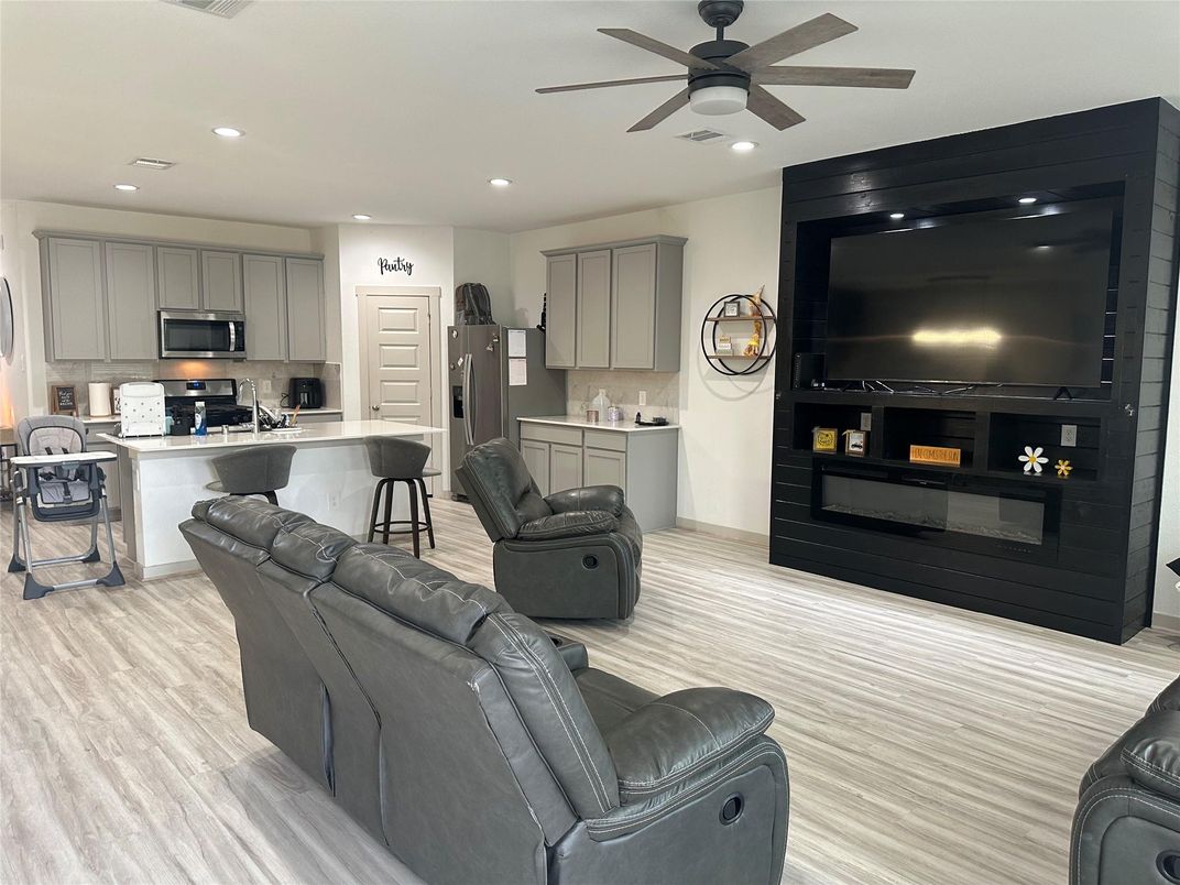Fireplace, Interior, Kitchen, Living room, Recessed Lighting, Stainless Steel Appliances, Wood Texture Flooring