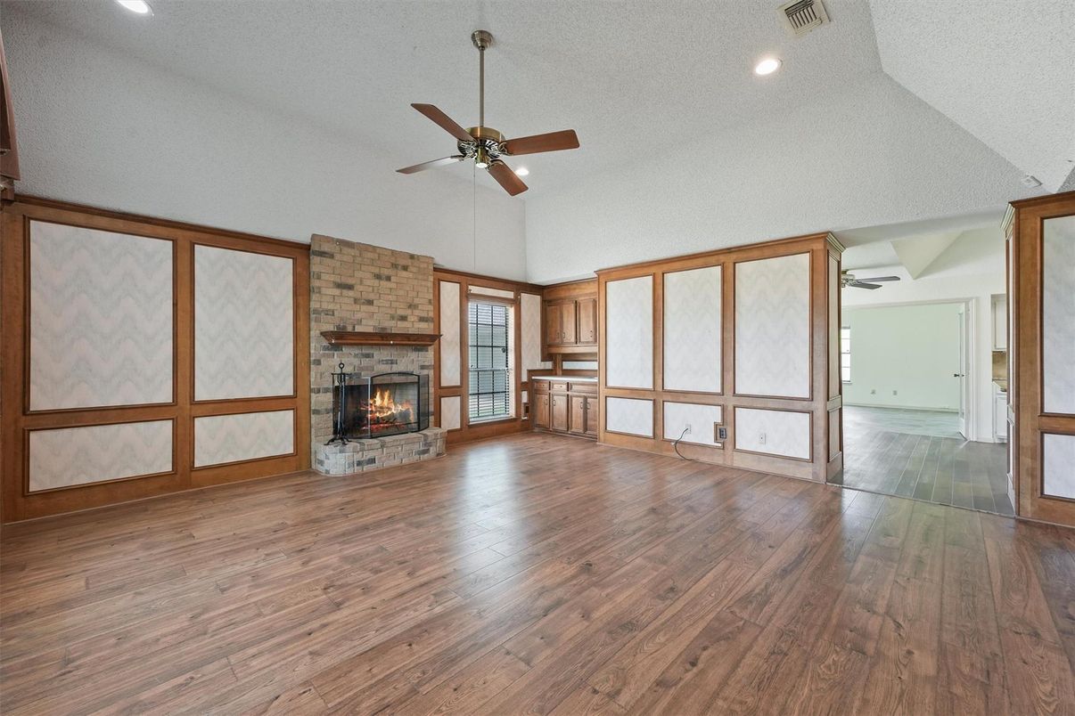 Empty room, Fireplace, Interior, Recessed Lighting, Stone Walls, Wood Texture Flooring