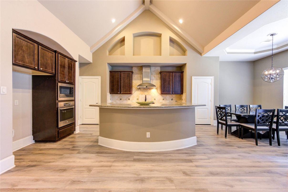 Chandelier, Dining room, Interior, Kitchen, Pendant Lights, Recessed Lighting, Stainless Steel Appliances, Wood Texture Flooring