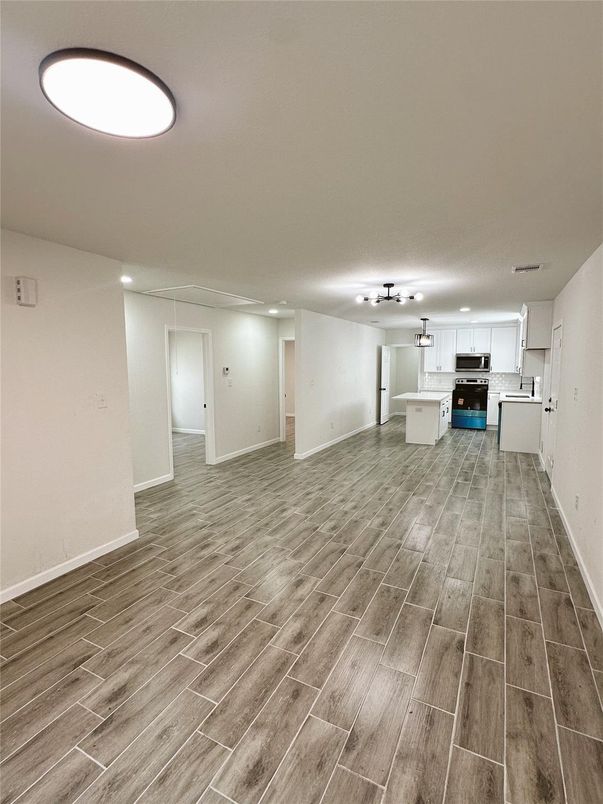 Empty room, Interior, Kitchen, Stainless Steel Appliances, Wood Texture Flooring