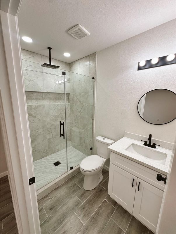 Bathroom, Glass Shower, Interior, Marble Walls, Recessed Lighting, Wood Texture Flooring