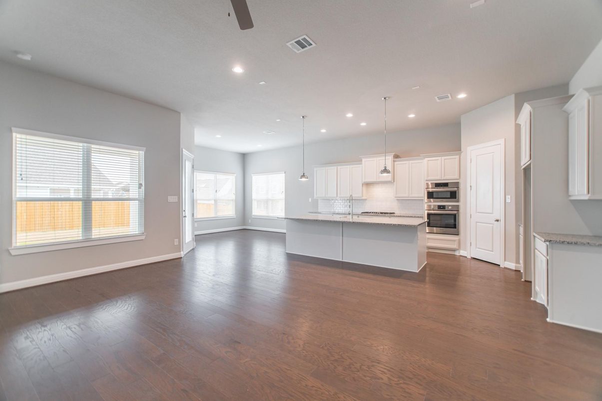 Empty room, Interior, Kitchen, Pendant Lights, Recessed Lighting, Stainless Steel Appliances, Wood Texture Flooring