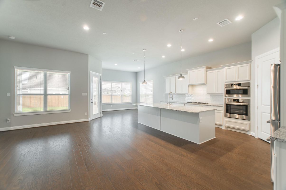 Empty room, Interior, Kitchen, Pendant Lights, Recessed Lighting, Stainless Steel Appliances, Wood Texture Flooring