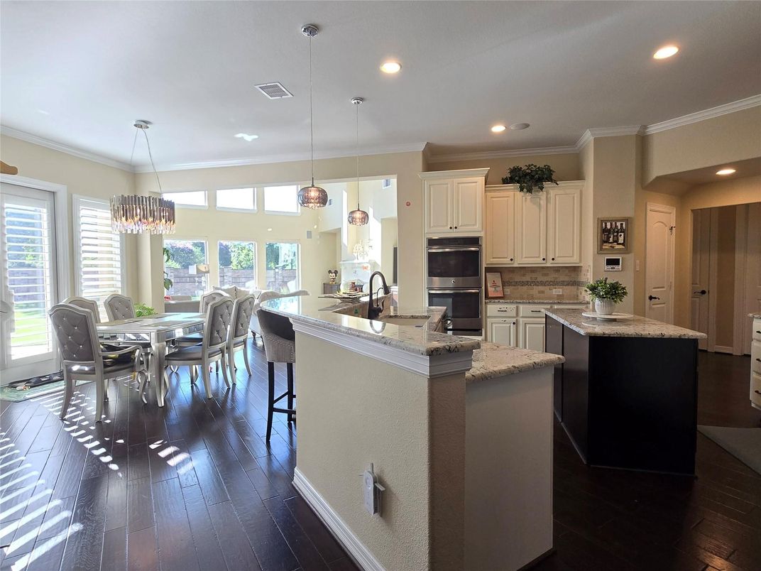 Chandelier, Dining room, Interior, Kitchen, Pendant Lights, Recessed Lighting, Stainless Steel Appliances, Wood Texture Flooring