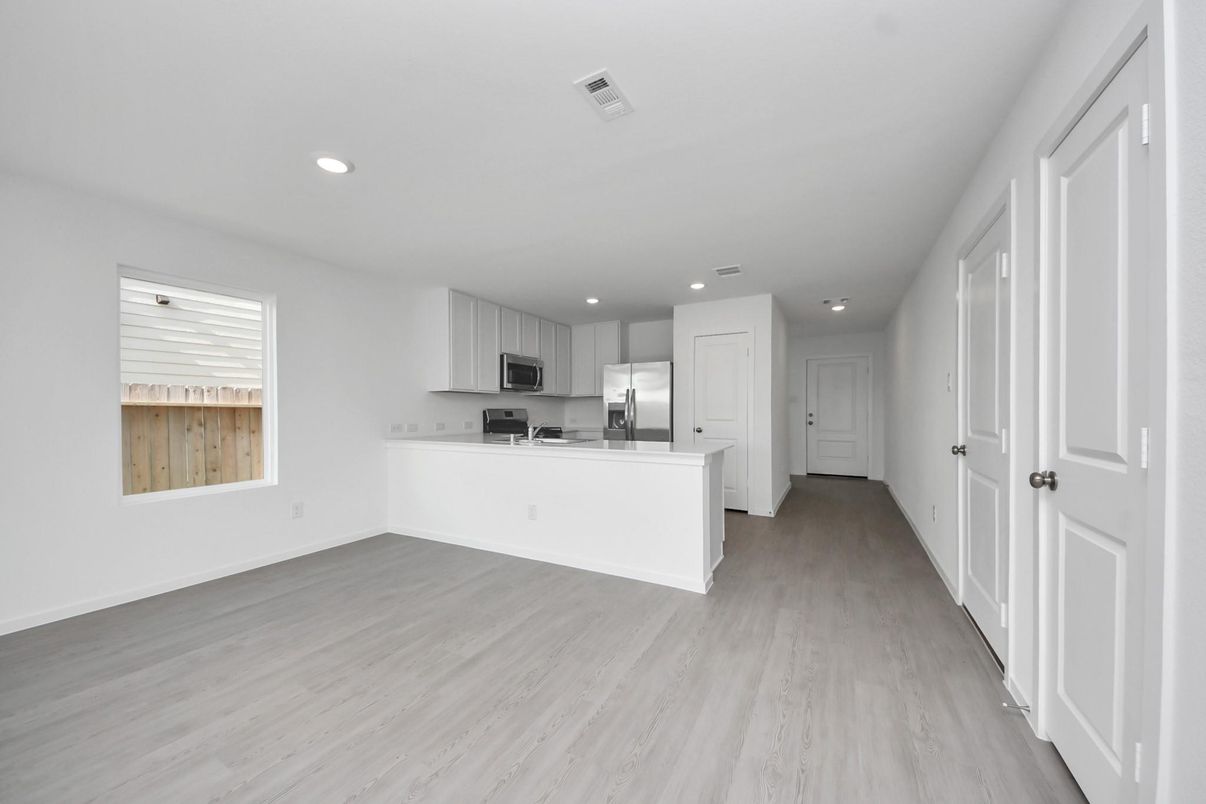 Empty room, Interior, Kitchen, Recessed Lighting, Stainless Steel Appliances, Wood Texture Flooring