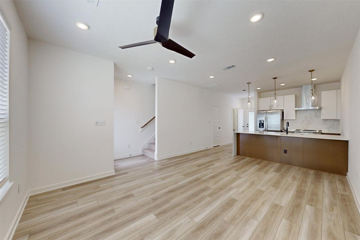 Empty room, Interior, Kitchen, Pendant Lights, Recessed Lighting, Stainless Steel Appliances, Wood Texture Flooring