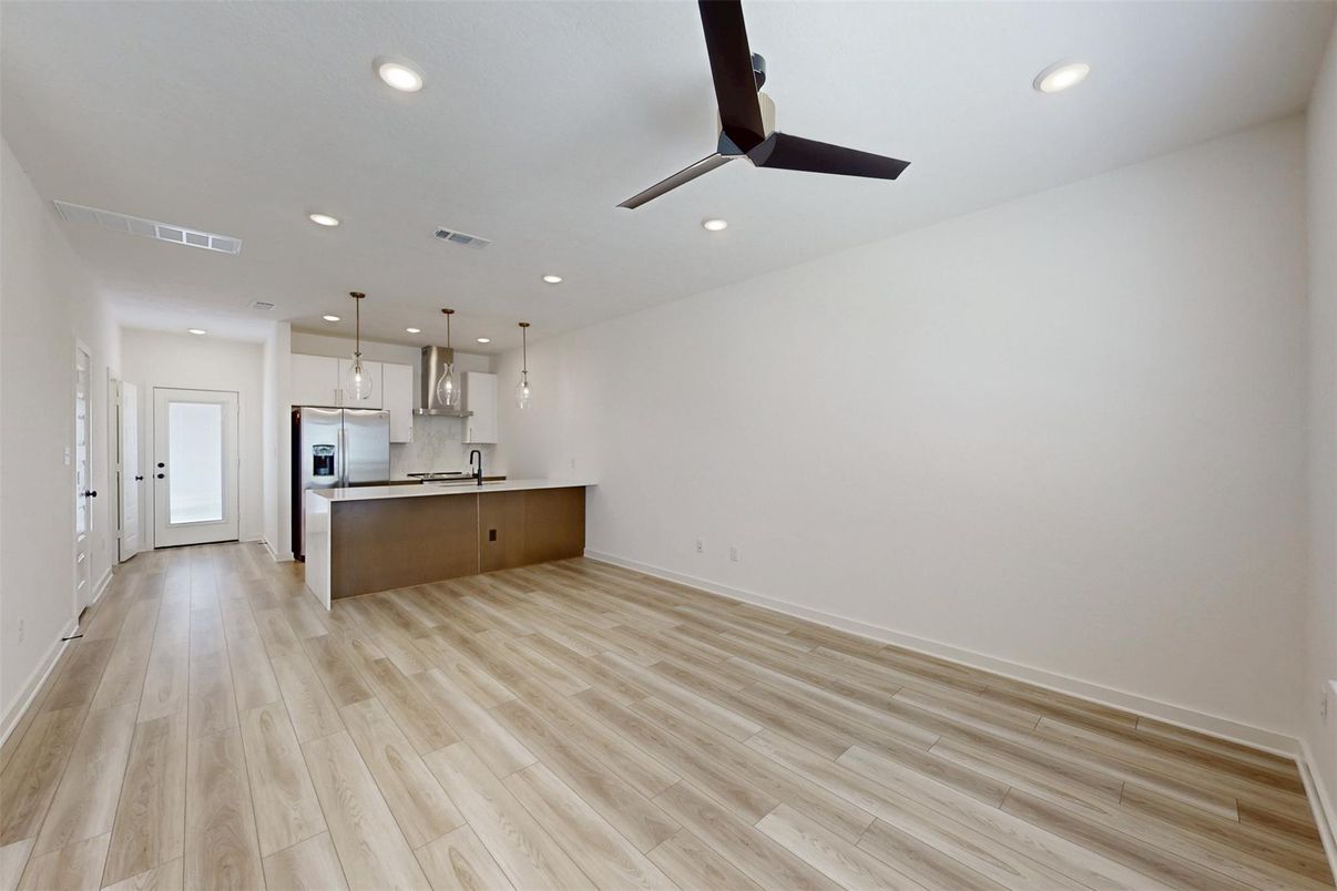 Empty room, Interior, Kitchen, Pendant Lights, Recessed Lighting, Stainless Steel Appliances, Wood Texture Flooring
