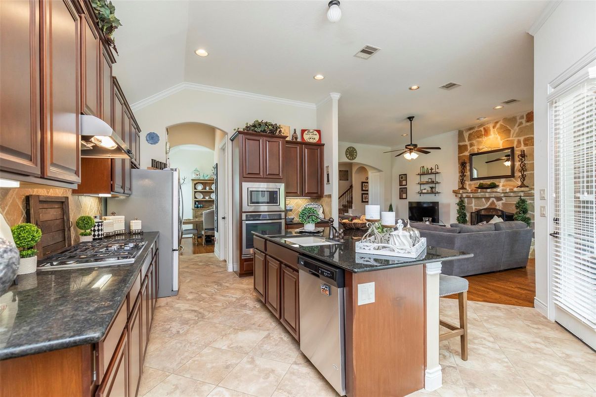 Fireplace, Interior, Kitchen, Living room, Recessed Lighting, Stainless Steel Appliances, Stone Walls, Wood Texture Flooring