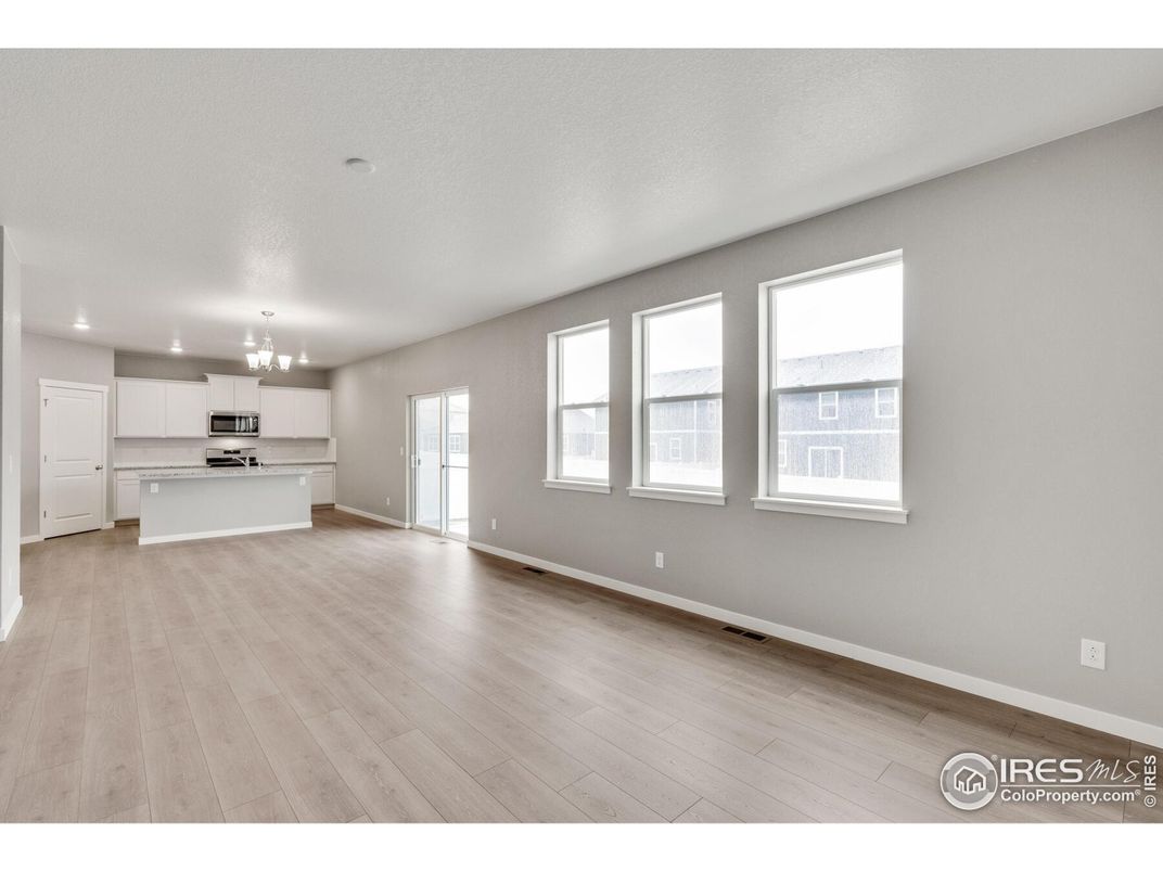 Chandelier, Empty room, Interior, Kitchen, Recessed Lighting, Stainless Steel Appliances, Wood Texture Flooring