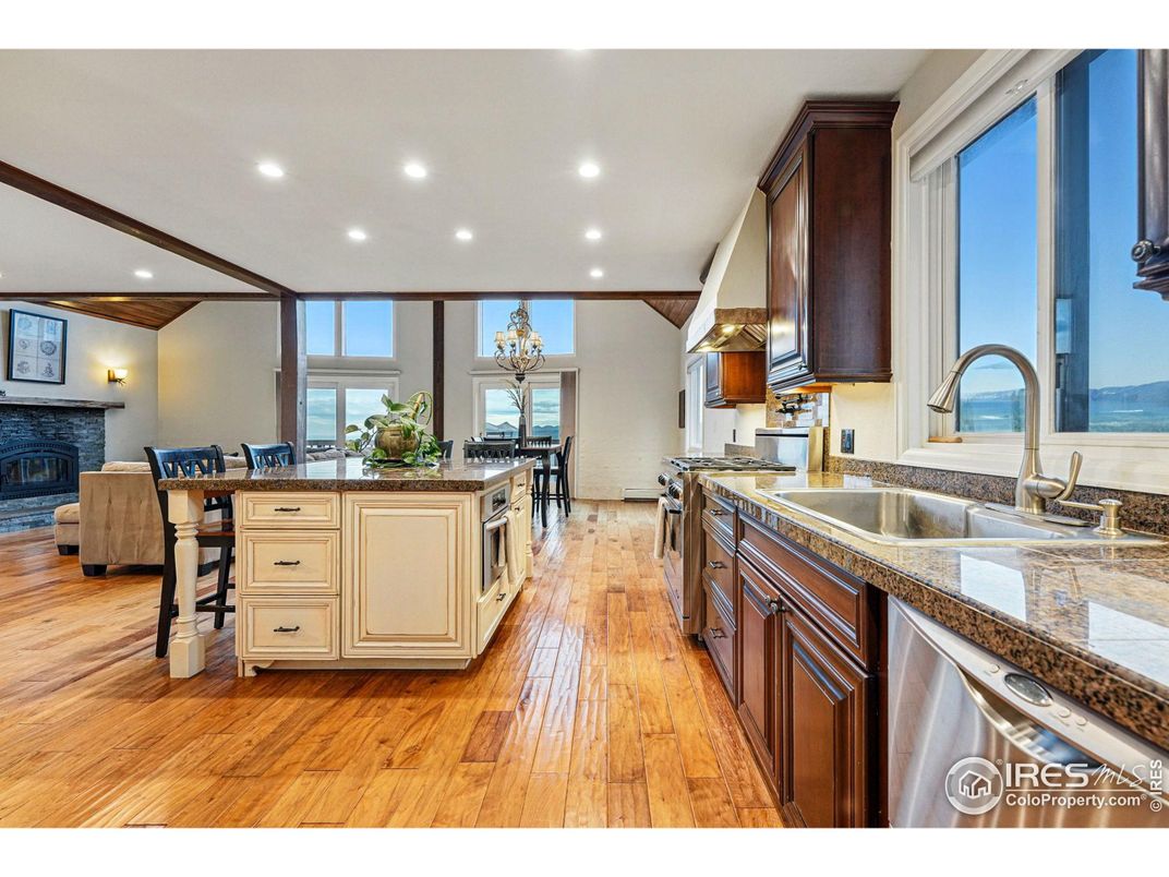 Dining room, Fireplace, Interior, Kitchen, Living room, Recessed Lighting, Stainless Steel Appliances, Wood Texture Flooring