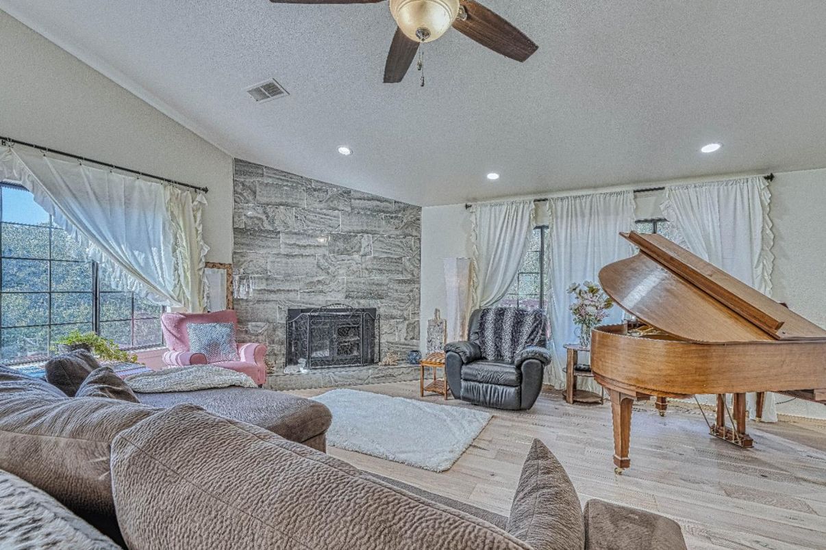Fireplace, Interior, Living room, Piano, Recessed Lighting, Stone Walls, Wood Texture Flooring