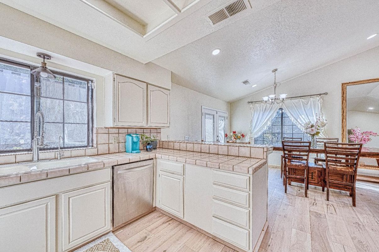 Chandelier, Dining room, Interior, Kitchen, Recessed Lighting, Tile Countertops, Wood Texture Flooring