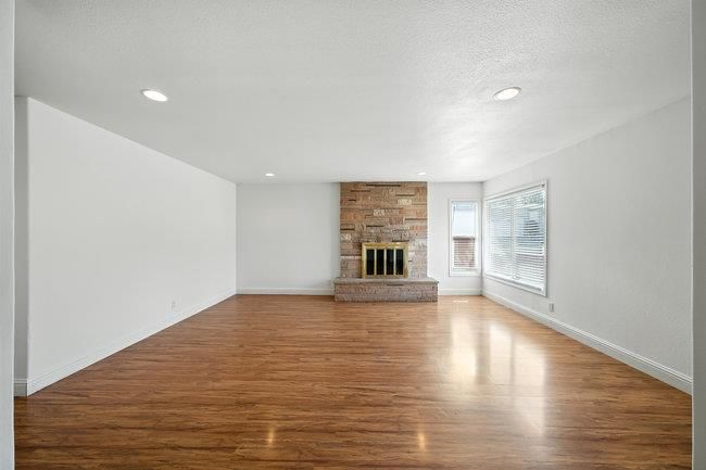Empty room, Fireplace, Interior, Recessed Lighting, Stone Walls, Wood Texture Flooring