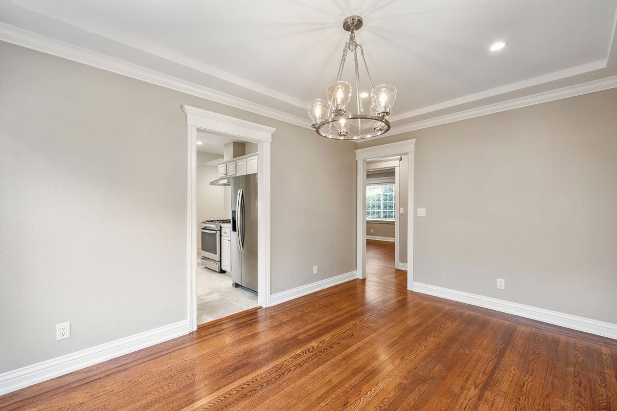 Empty room, Interior, Kitchen, Pendant Lights, Recessed Lighting, Stainless Steel Appliances, Wood Texture Flooring