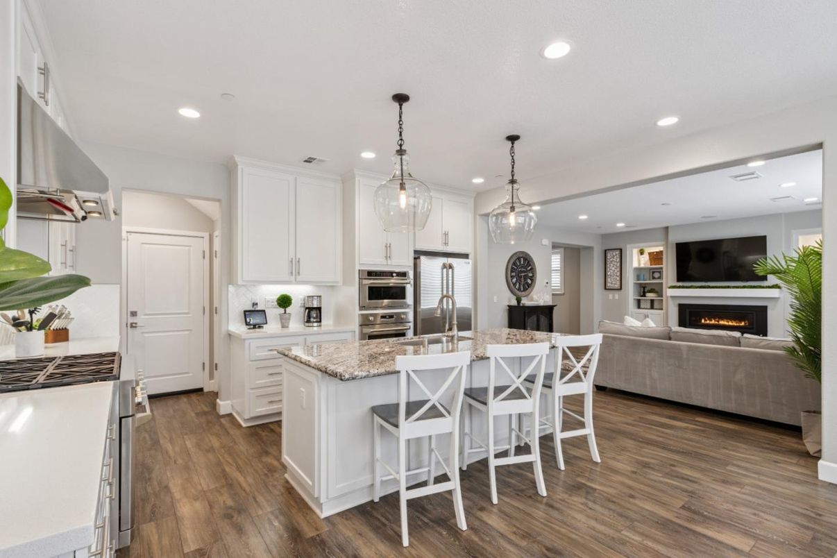 Fireplace, Interior, Kitchen, Living room, Pendant Lights, Recessed Lighting, Stainless Steel Appliances, Wood Texture Flooring