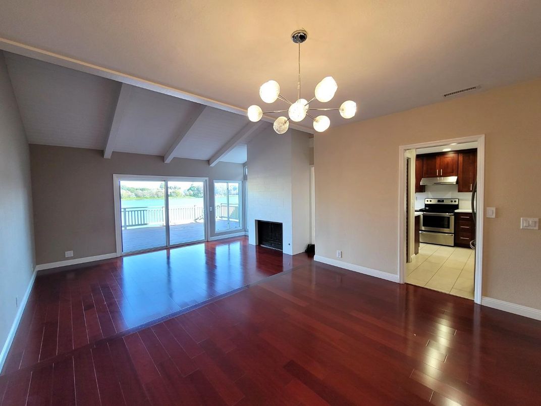 Empty room, Interior, Kitchen, Pendant Lights, Stainless Steel Appliances, Wood Texture Flooring