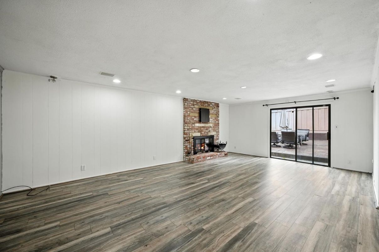 Empty room, Fireplace, Interior, Recessed Lighting, Stone Walls, Wood Texture Flooring