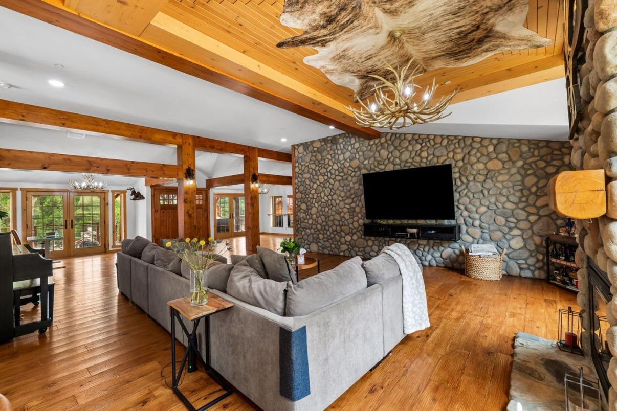 Chandelier, Fireplace, Interior, Living room, Recessed Lighting, Stone Walls, Wooden Beams, Wooden Ceilings, Wood Texture Flooring
