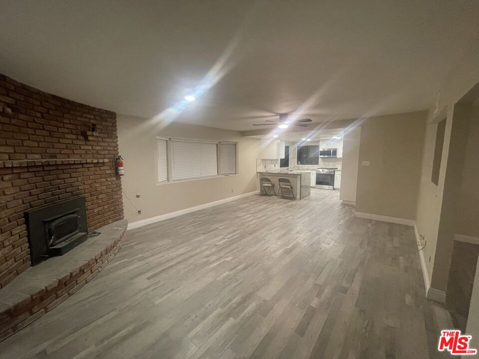 Empty room, Fireplace, Interior, Recessed Lighting, Stone Walls, Wood Texture Flooring