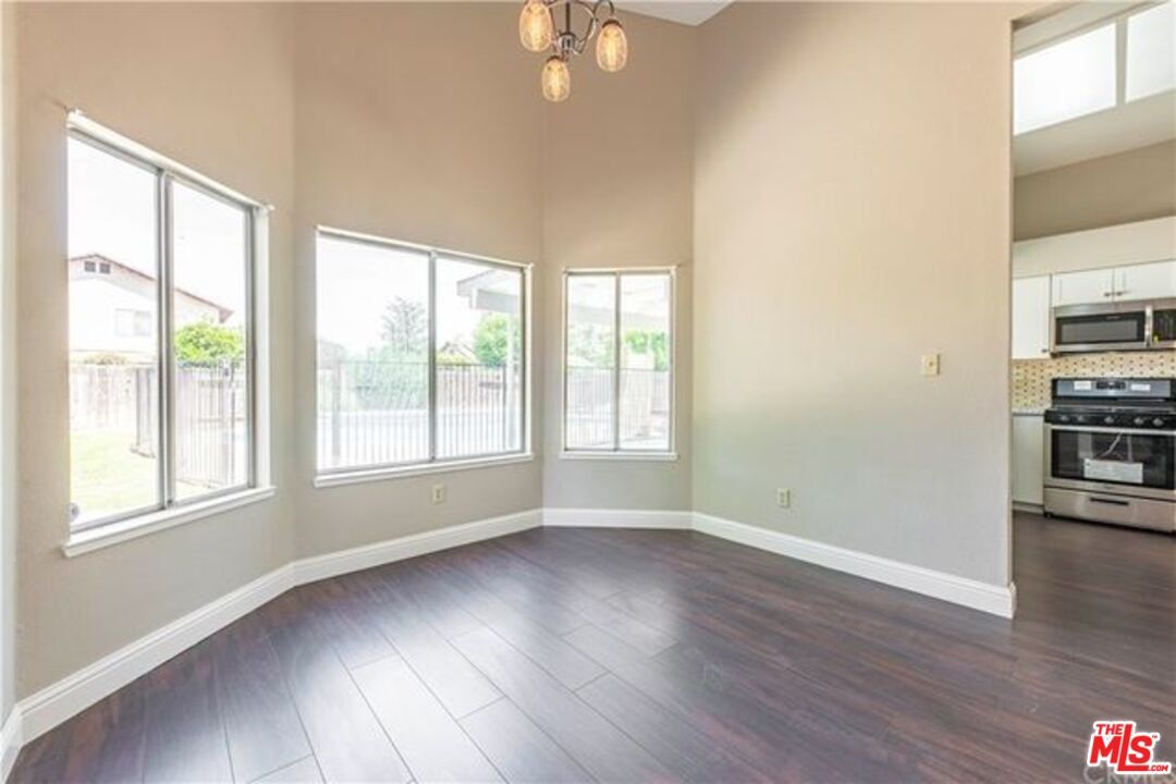 Empty room, Interior, Kitchen, Pendant Lights, Stainless Steel Appliances, Wood Texture Flooring