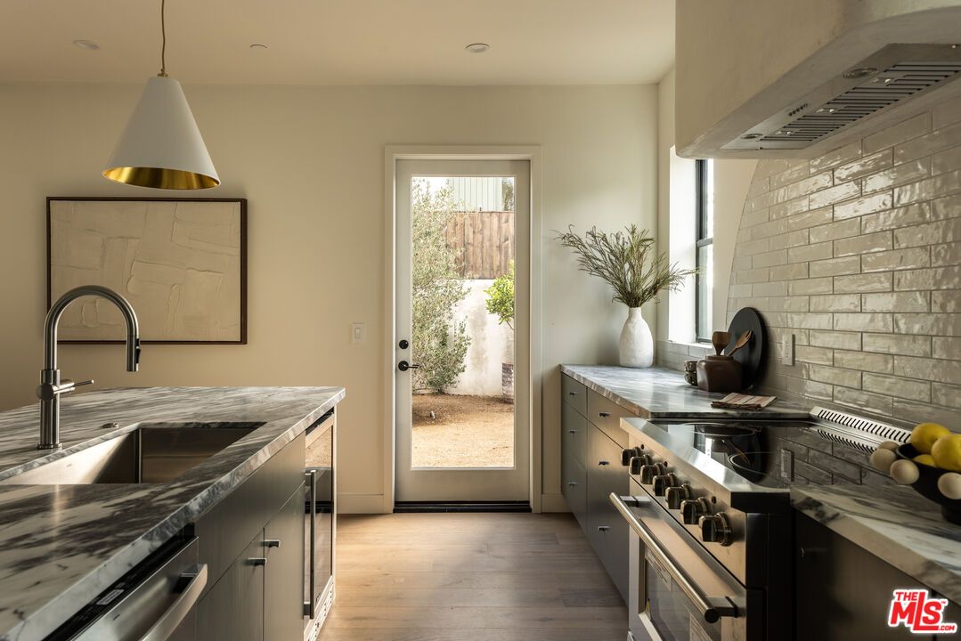 Interior, Kitchen, Pendant Lights, Recessed Lighting, Stainless Steel Appliances, Stone Walls, Wood Texture Flooring